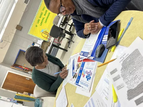 Image is of Linda Little speaking with member, Yolanda Polk 