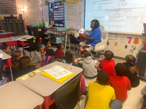 Image of President Jones reading with students at Northside Elementary